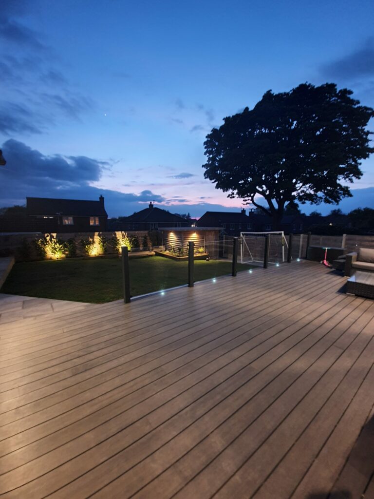 composite decking in twilight with a tree in the background