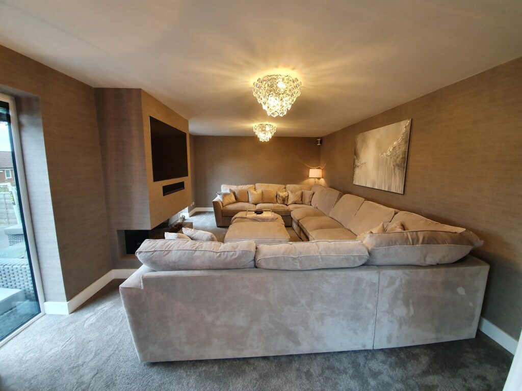 extension with a large couch and a tv